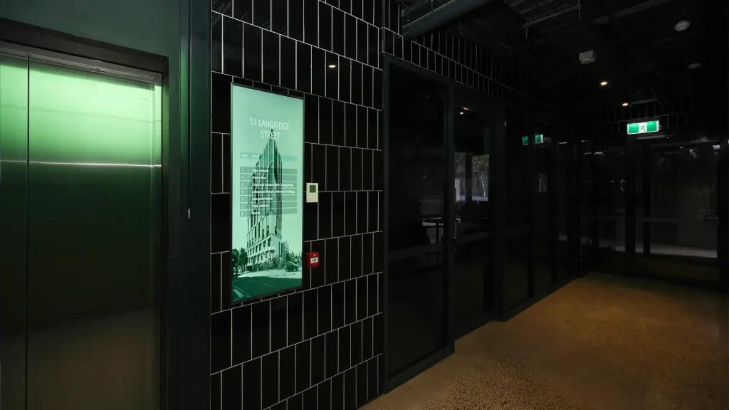 Streamline Series Digital Tenant Directory in the tiled corridor lift lobby of 51 Langridge Street Collingwood.
